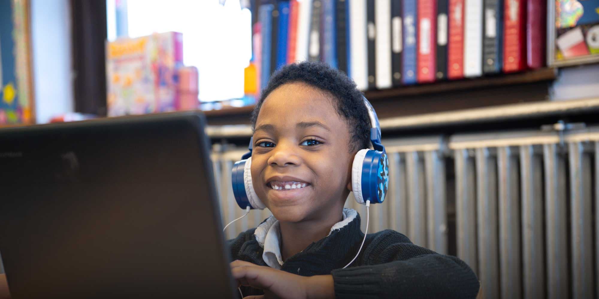 Student wearing headphones and working on computer